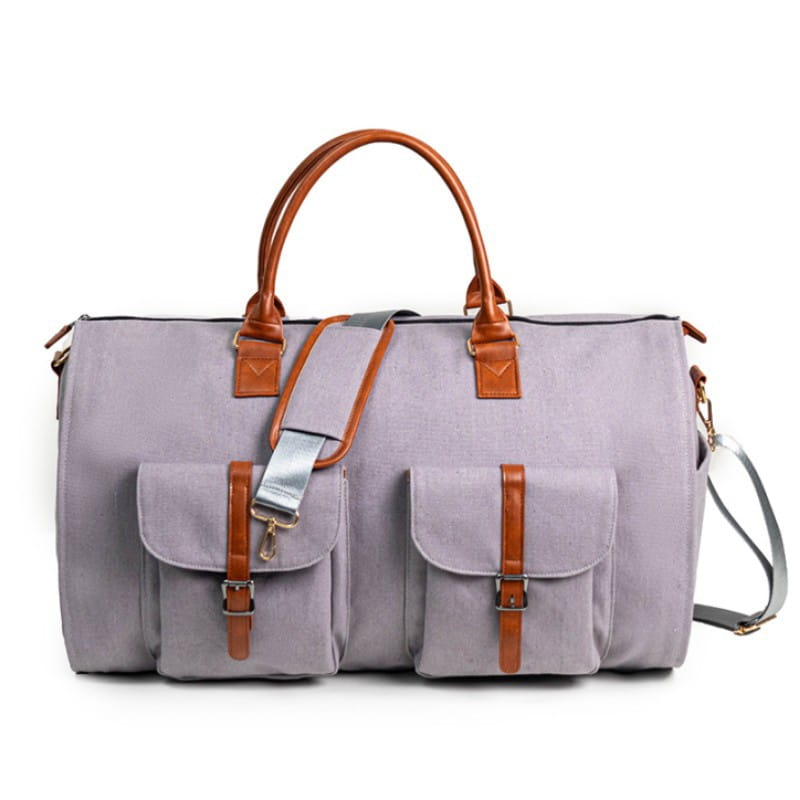 A lavender multifunctional canvas and leather folding travel duffel bag with tan leather handles and straps featuring two front flap pockets secured by brown leather buckles.