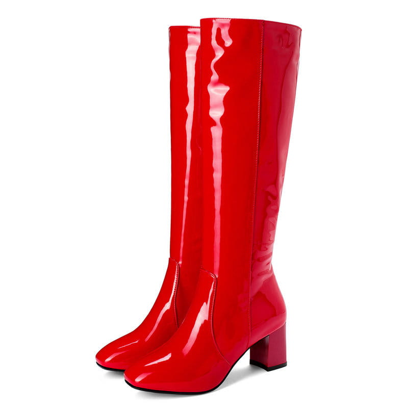 A pair of glossy red patent leather knee high boots with a square toe and block heel.
