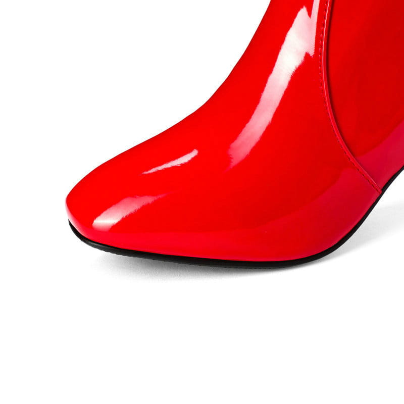Vibrant red patent leather ankle boot with a sleek glossy finish and black sole featured in patent leather knee high block heel square toe boots.