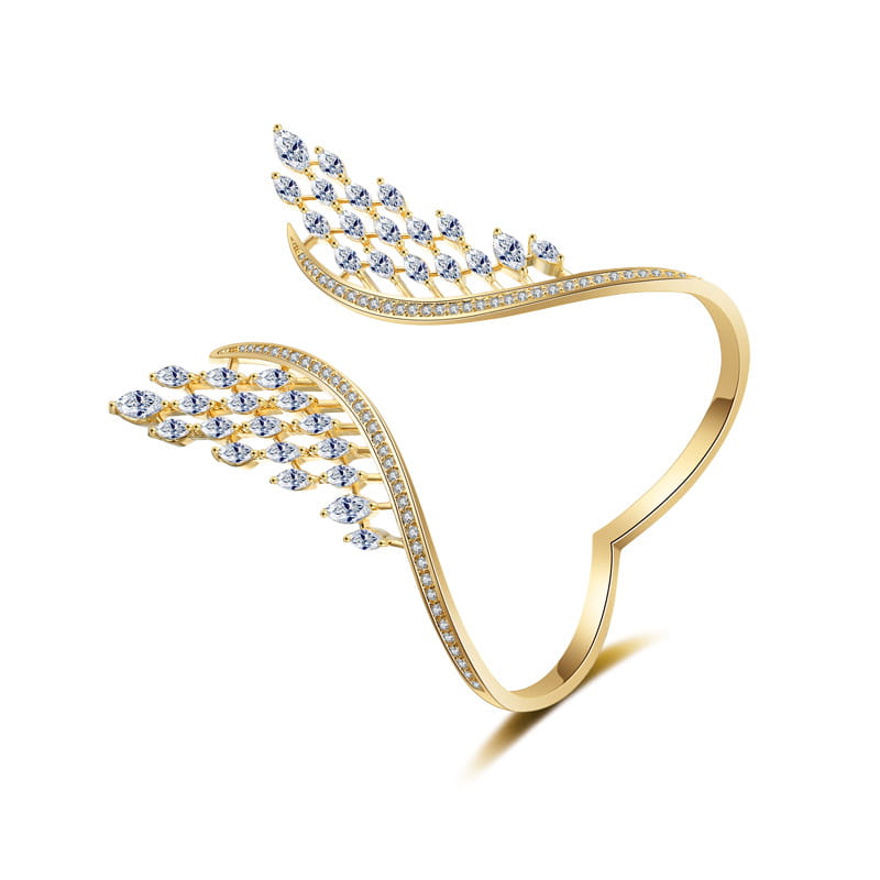Gold-toned angel wing ring with clear marquise and round-cut crystals along its curved bands featured in the marquise crystal angel wing bangle bracelet collection.
