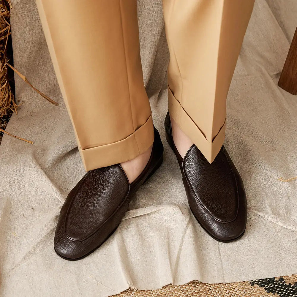 Dark brown textured cowhide leather loafers with a pointed toe and classic slip-on design.