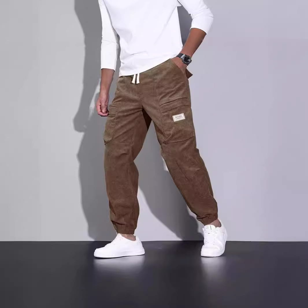 men corduroy cargo pants in brown feature multiple pockets and a drawstring waist for a loose casual fit.