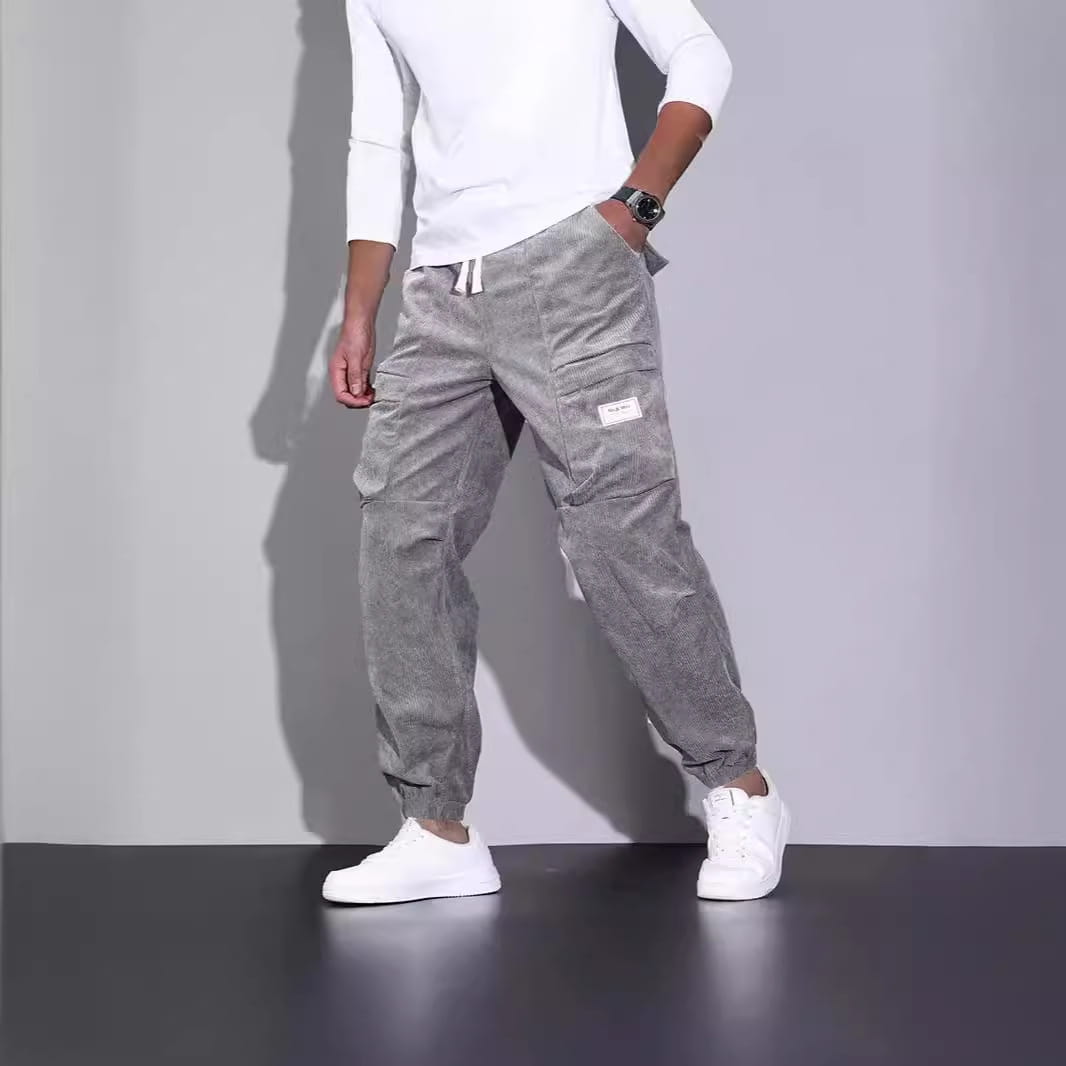 Men corduroy cargo pants loose casual drawstring trousers in gray featuring multiple pockets and a drawstring waist.