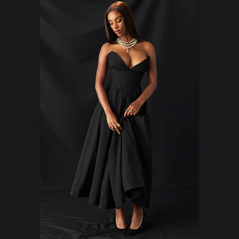 Black strapless corset style gown with a cinched waist and flared midi skirt designed for elegant occasions.