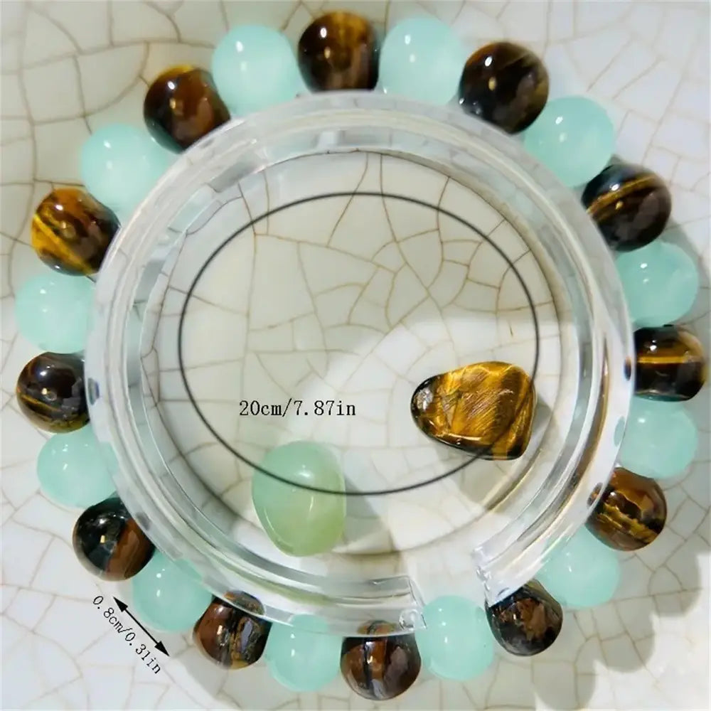 Natural tiger eye and green aventurine beaded bracelet featuring a circular design with alternating light blue jade and golden tiger eye beads.