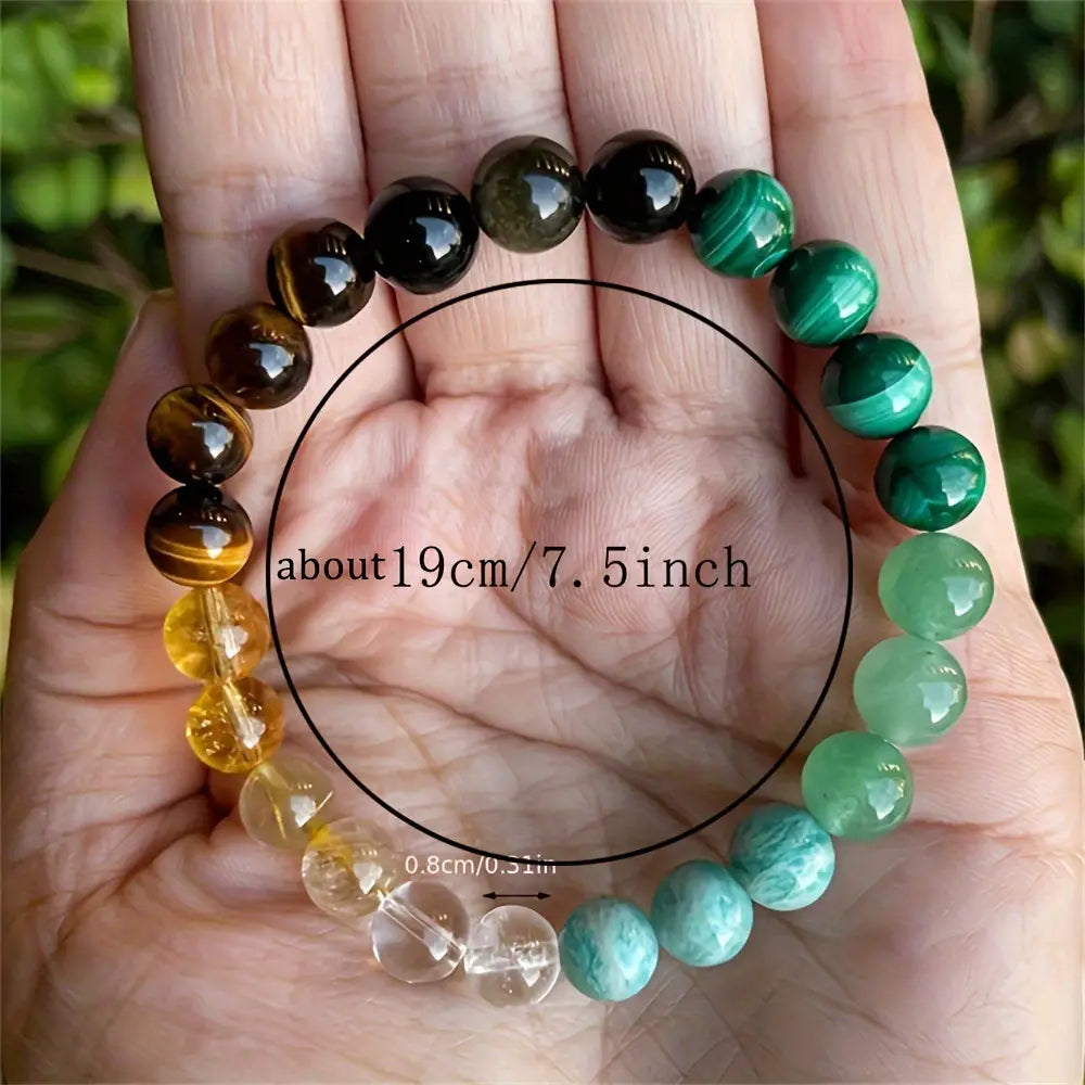A hand holds a 19cm natural multi-gemstone beaded bracelet with healing crystals featuring polished round stones in deep green malachite, golden tiger’s eye, amber citrine, clear quartz, and teal aventurine.