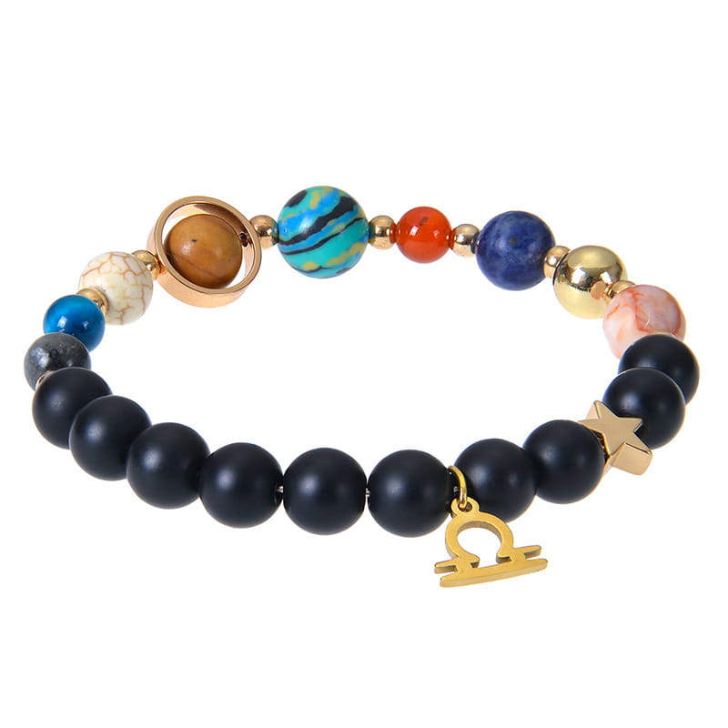 A celestial zodiac planet matte stone beaded bracelet featuring black matte beads, vibrant blue orange and turquoise gemstones, a gold-toned Libra charm, and a planetary-themed bead with a rose-gold ring.