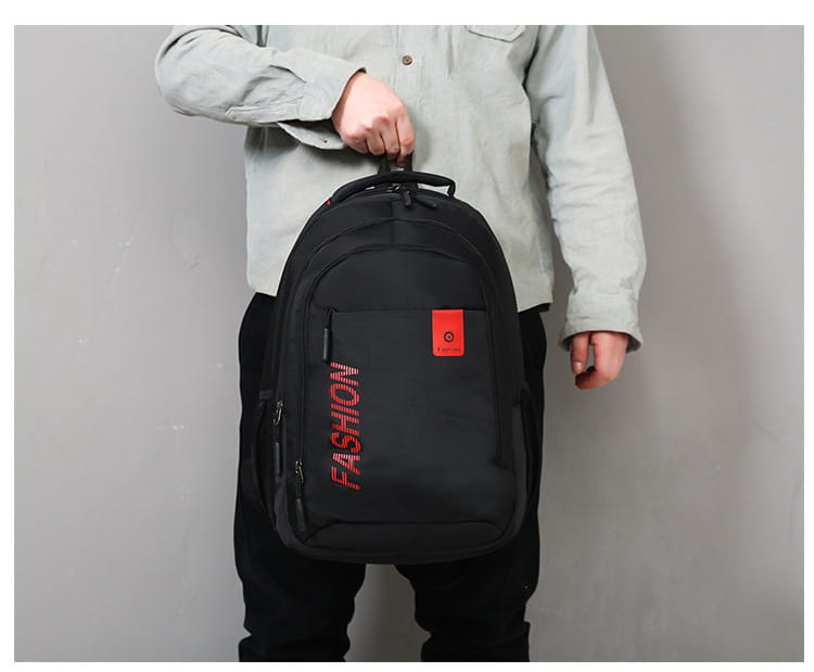 Men’s laptop backpack in black nylon canvas featuring red fashion lettering and a small orange patch on the front for school use.