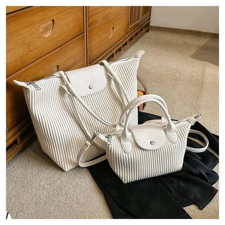 Cream-colored ribbed pu leather tote bags with top handles and detachable shoulder straps from the pleated shoulder bag minimalist collection.