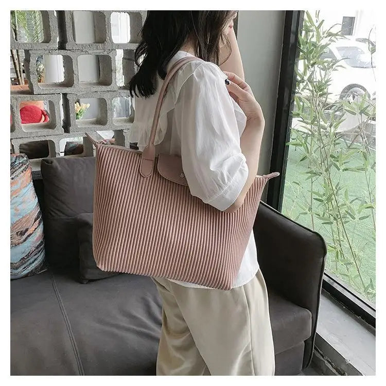 A soft pink pleated minimalist PU leather tote shoulder bag with a matching top handle and zipper closure.