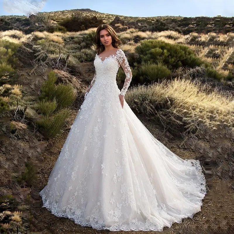 A white lace off shoulder long sleeve bridal wedding gown with a voluminous skirt.