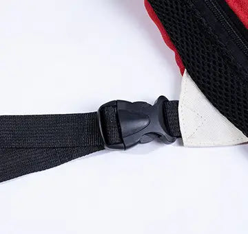 black adjustable strap with plastic buckle attached to red and white mesh panel on the back of a pet carrier backpack dog front pack denim vest