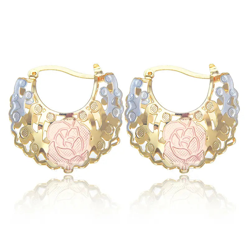 Two tone rose motif hoop earrings in gold and silver feature intricate floral detailing with a central pink enamel rose design.