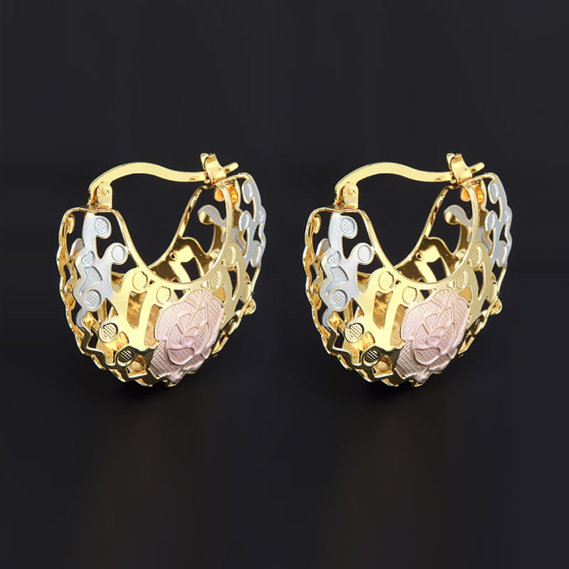 Two tone rose motif heart-shaped hoop earrings featuring gold silver and rose gold three-tone metal with intricate floral filigree design and pink enamel accents.
