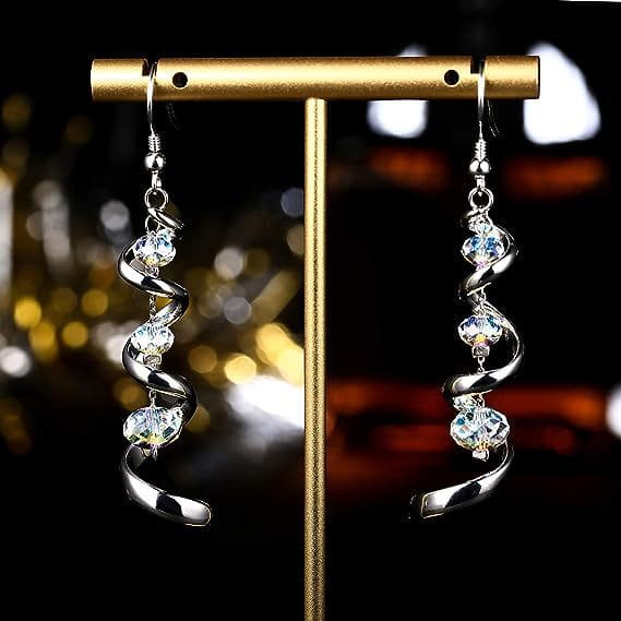 Silver spiral crystal teardrop dangle earrings featuring clear faceted crystals and crafted from silver.