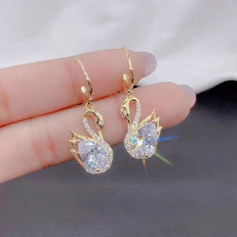Gold-toned crystal rhinestone swan drop earrings for women featuring a sparkling pave-set crystal body and intricate detailing along the neck and wings.