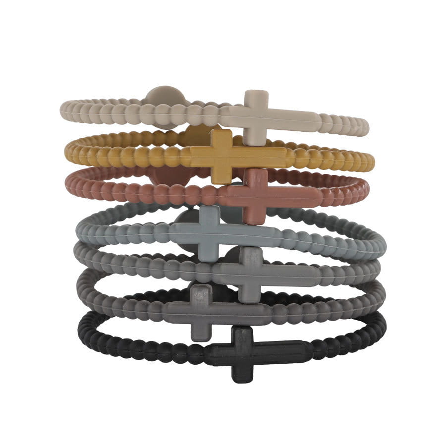 A stack of beaded silicone cross bracelets with round clasps in earthy tones including beige mustard yellow terracotta gray and black.