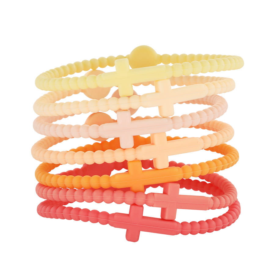 A stack of pastel-colored beaded silicone cross bracelets with round clasps featuring textured bands and central cross charms.
