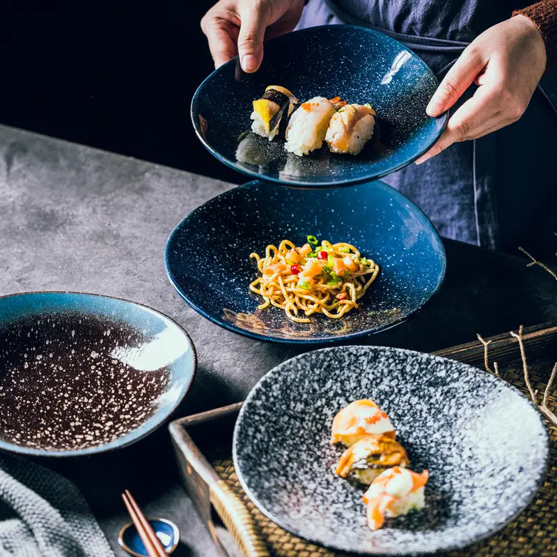 Deep blue ceramic round corner fillet plate with a speckled textured glaze in Nordic design.