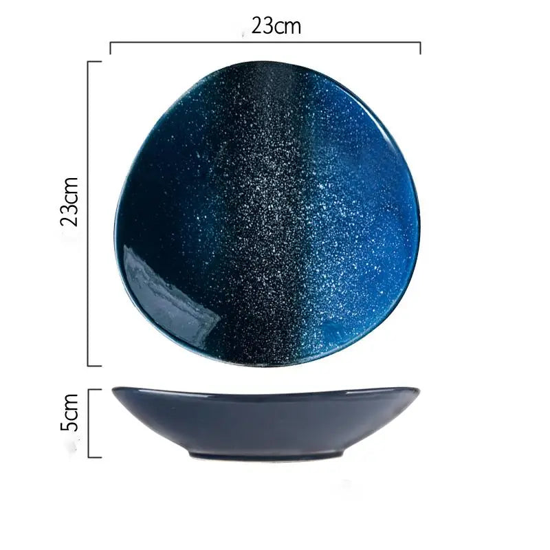 A glossy ceramic blue speckled Nordic round corner fillet plate with an oval shape and a gradient from deep navy to vibrant blue with fine metallic glints.