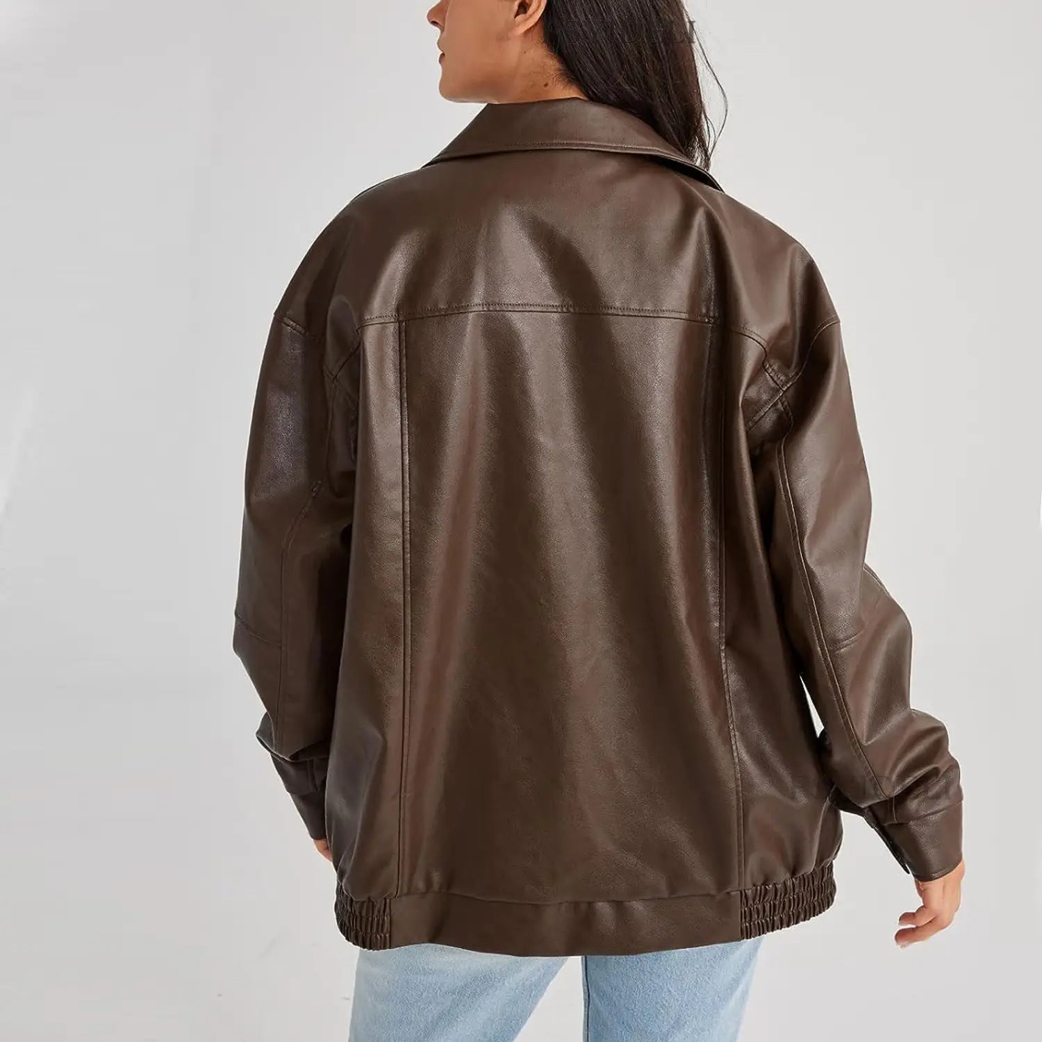 A sleek chocolate brown faux leather bomber jacket with a relaxed fit and elasticized cuffs for women.