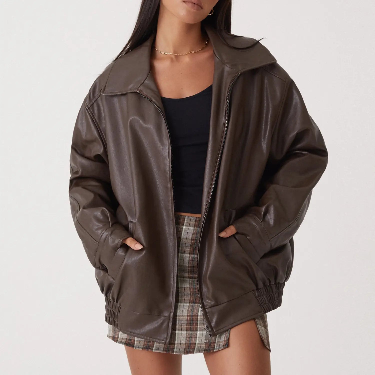 A dark brown faux leather bomber jacket for women featuring a relaxed fit and ribbed cuffs.