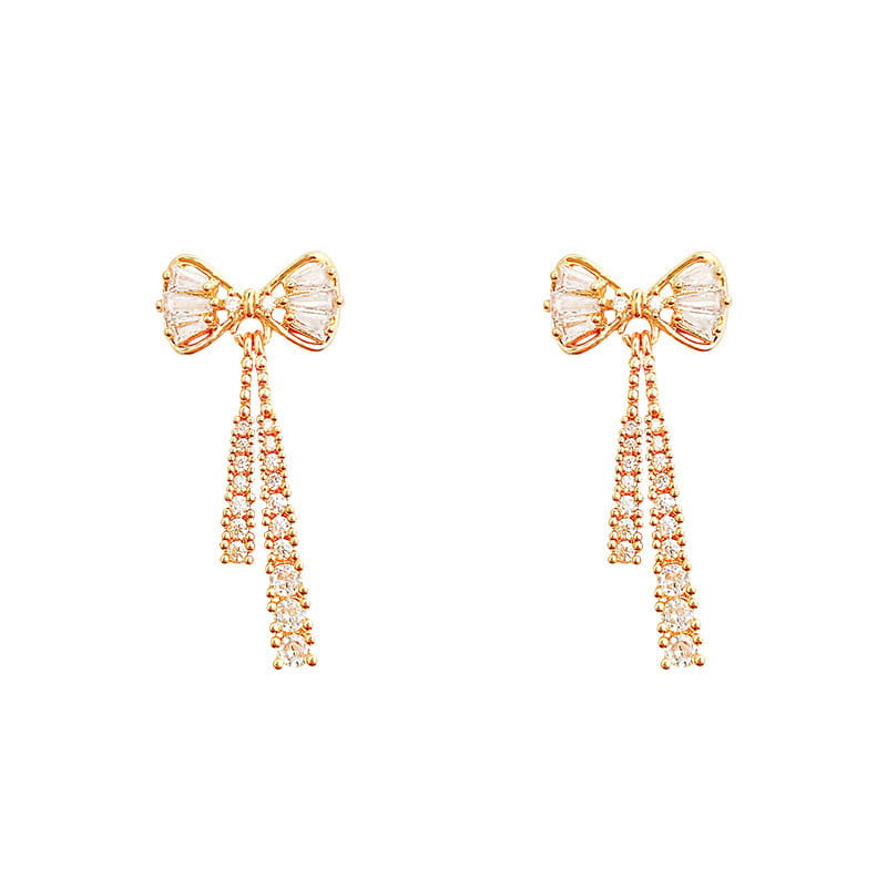 Rose gold bow-shaped earrings featuring clear faceted crystals and dangling crystal strands designed as crystal bow and pearl dangle earrings in gold.