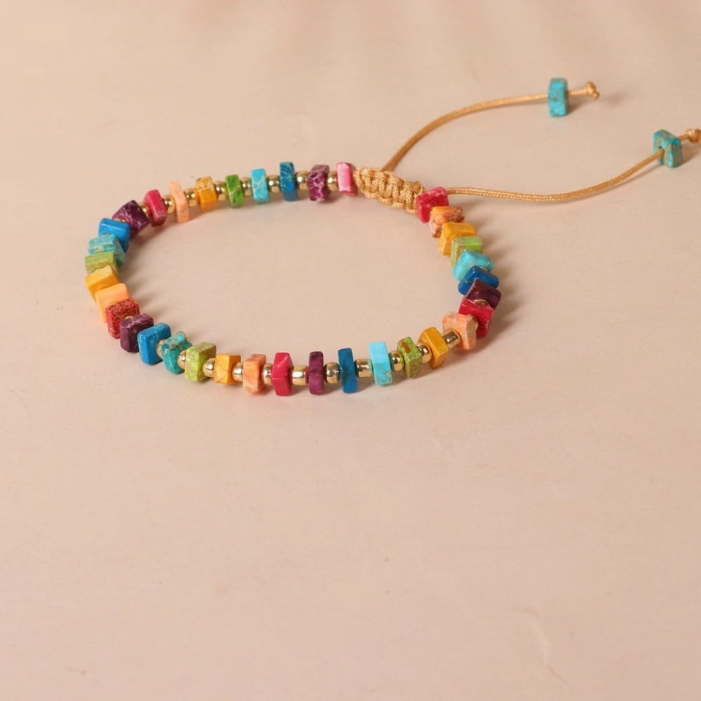 Handcrafted rainbow square stone woven yoga bracelet with colorful beaded square and round stones on a tan adjustable cord.