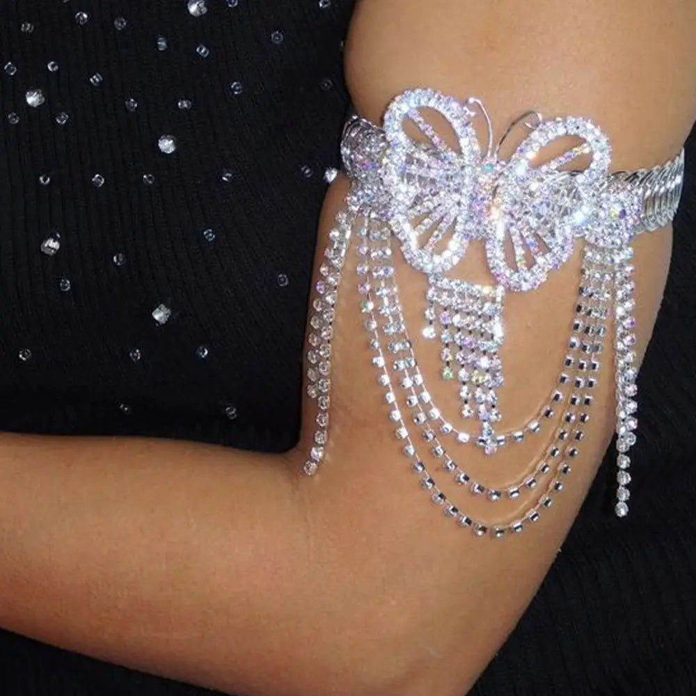 A sparkling silver rhinestone butterfly arm cuff with cascading crystal chains from the Fairy Butterfly Rhinestone Tassel Arm Chain Bracelet collection.