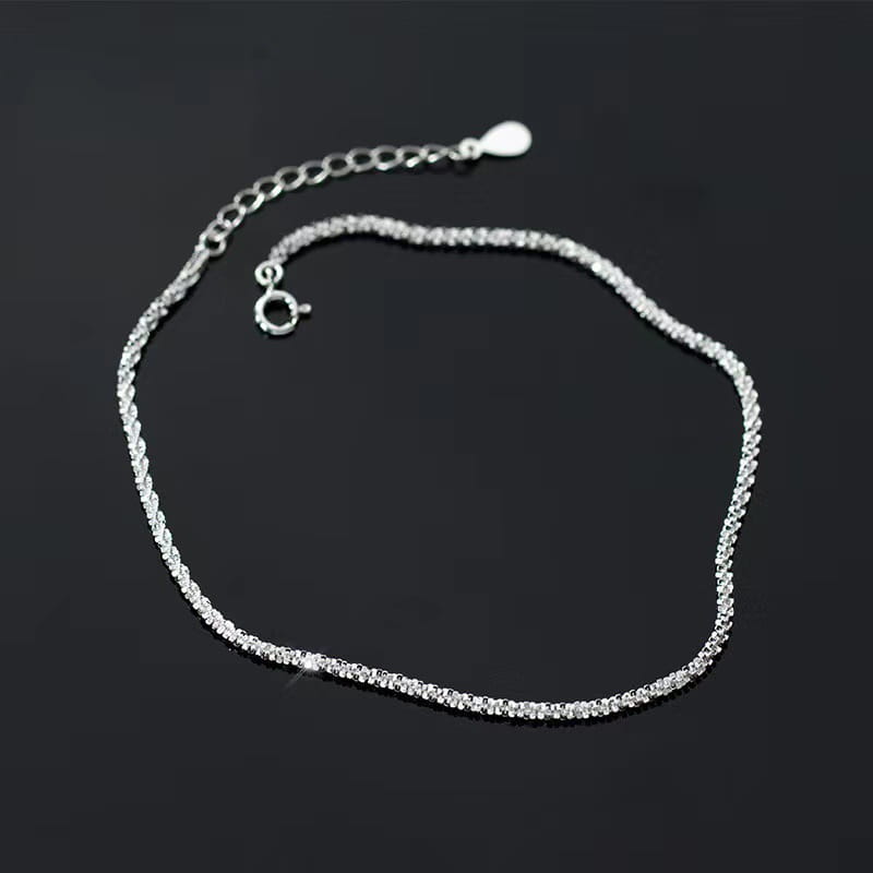 Adjustable 925 silver sparkling crystal ankle bracelet featuring a silver-toned twisted chain design with embedded clear crystals.