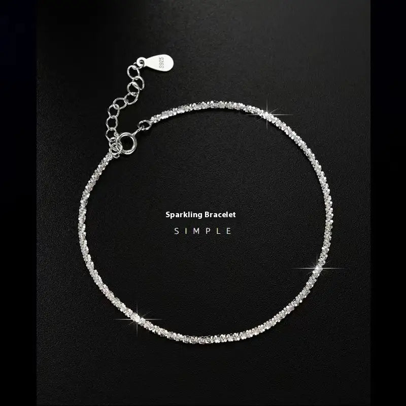 An adjustable 925 silver bracelet and anklet set featuring a delicate design with a continuous line of sparkling clear crystals.