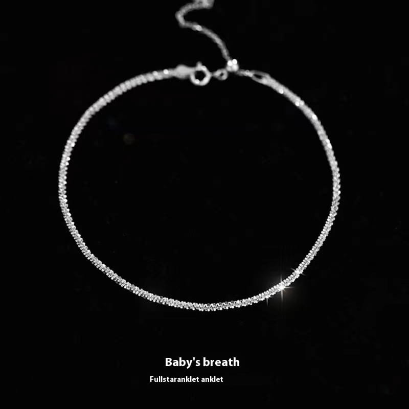 A delicate silver anklet from an adjustable 925 silver sparkling crystal bracelet and anklet set featuring a fine sparkling chain with embedded crystals and a secure clasp.