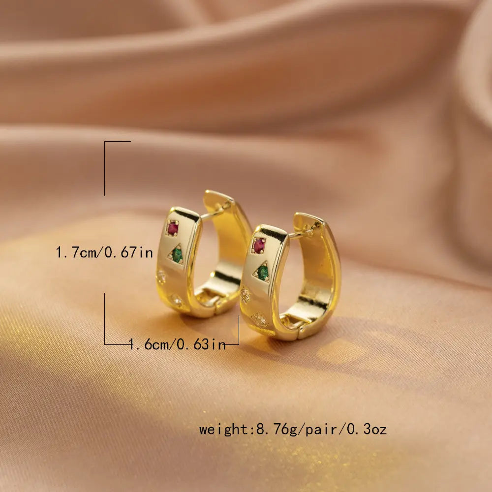 gold-colored geometric multi color zircon huggie hoop earrings with embedded red and green gemstones