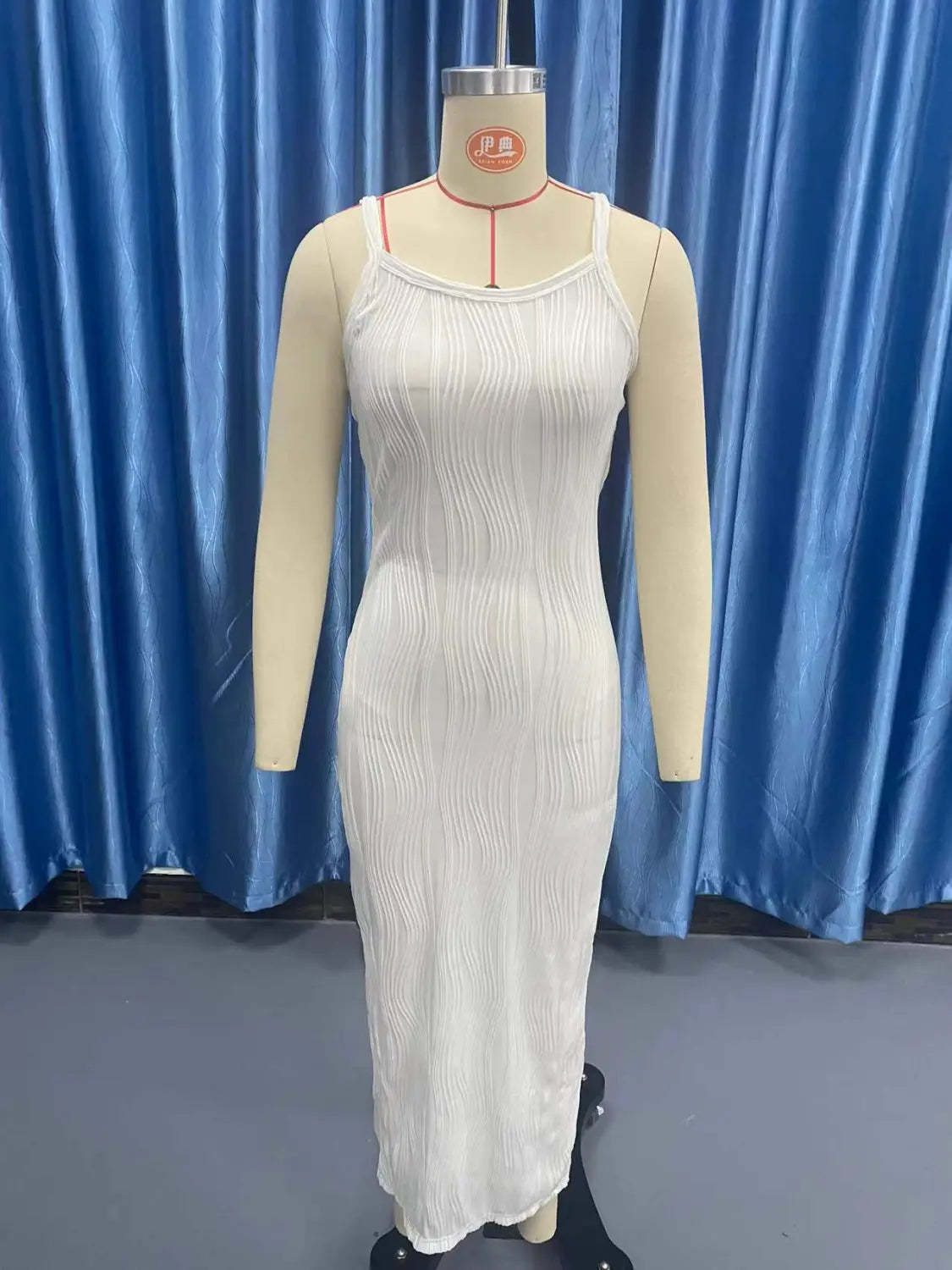 white ribbed knit midi dress with pleated skirt and spaghetti straps featuring a square neckline and sleeveless design