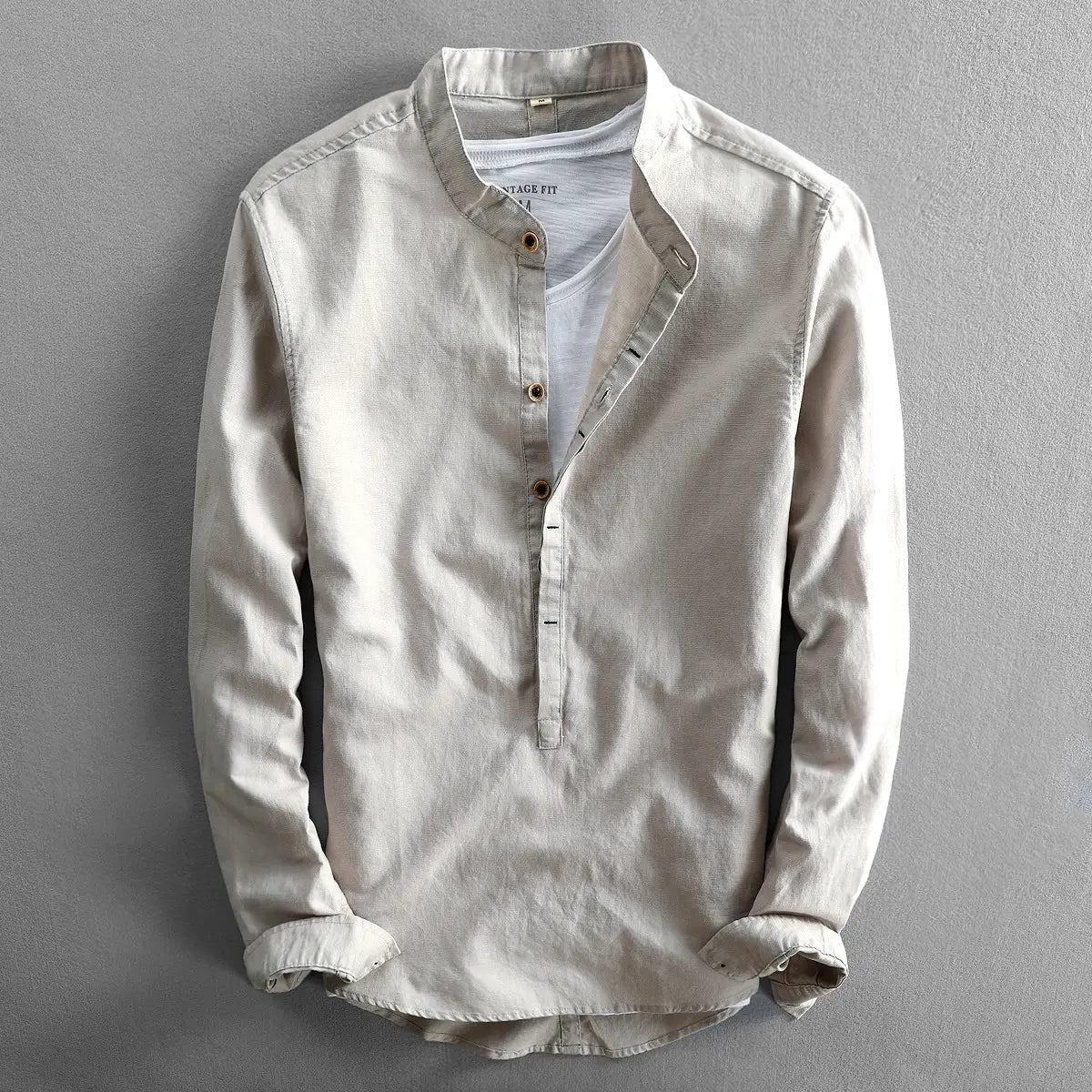 Beige men’s loose linen long sleeve shirt with mandarin collar and subtle stitching details.