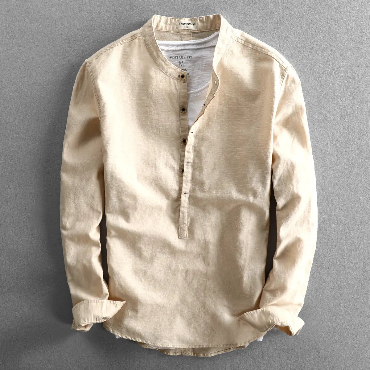 Beige linen men’s loose long sleeve shirt with a mandarin collar and button-down front.