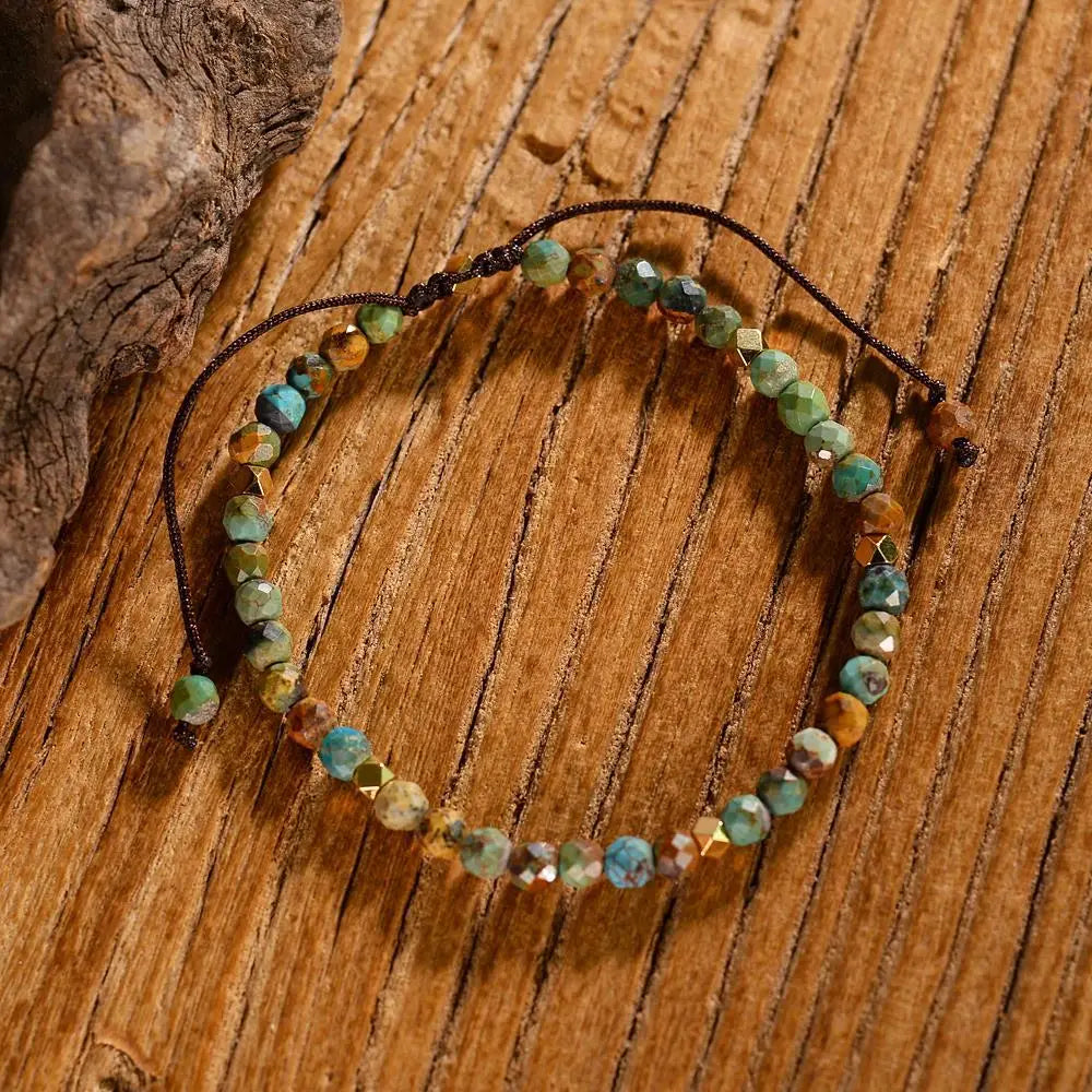 Adjustable African turquoise braided leather bracelet handcrafted with faceted turquoise and earthy brown stones strung on a dark cord with adjustable knots.