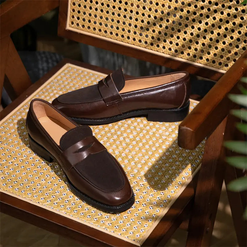 Brown leather two tone square toe loafers with a classic slip-on design and a single strap across the toe.