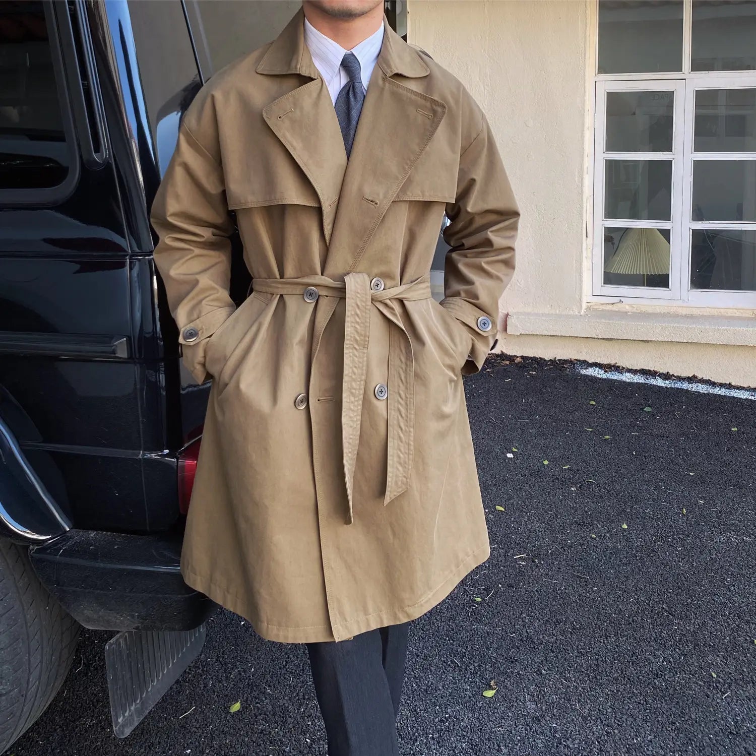 Beige double breasted trench coat men with a belted waist and classic collar designed for stylish outerwear.