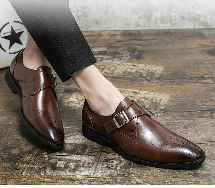 Black leather monk strap dress shoe with polished finish and perforated detailing for men.