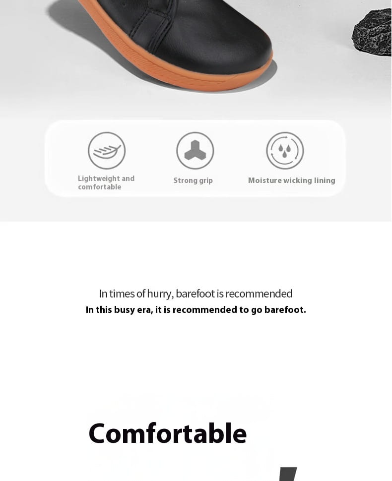 Zapatilla minimalista antideslizante de cuero negro de puntera ancha con suela naranja, mostrada desde el lado posterior.