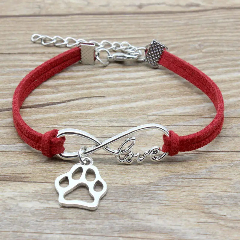 Red suede hand-woven infinite love pet paw bracelet with silver infinity charm engraved with love and a paw print pendant.