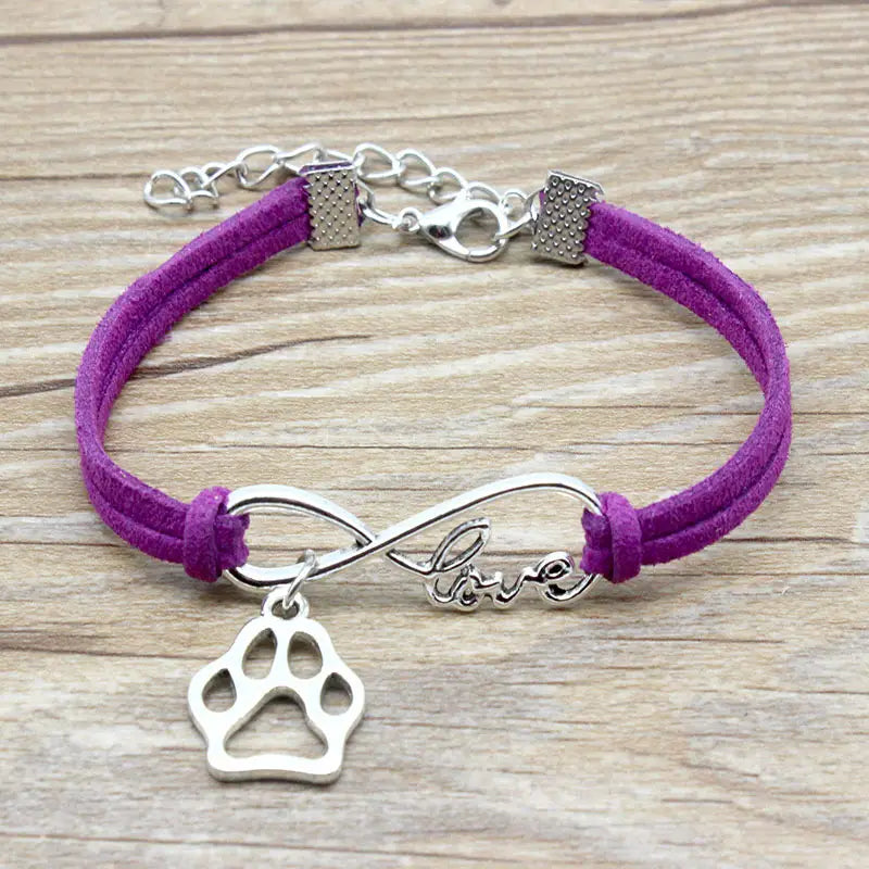 Purple suede bracelet with silver infinity charm engraved with love and a paw print pendant in a hand-woven infinite love pet paw suede bracelet.