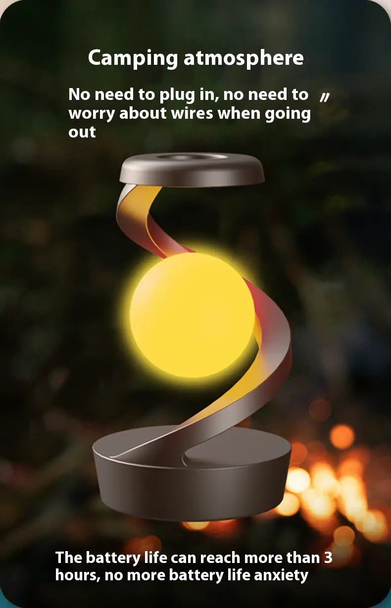 A sleek modern moon desk lamp with wireless charging and sensor control featuring a glowing yellow sphere suspended between two dark gray circular bases by a twisted metallic band.