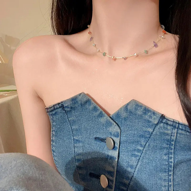 A delicate multicolor gemstone choker necklace with a fine gold-toned chain made from gold and silver alloy.