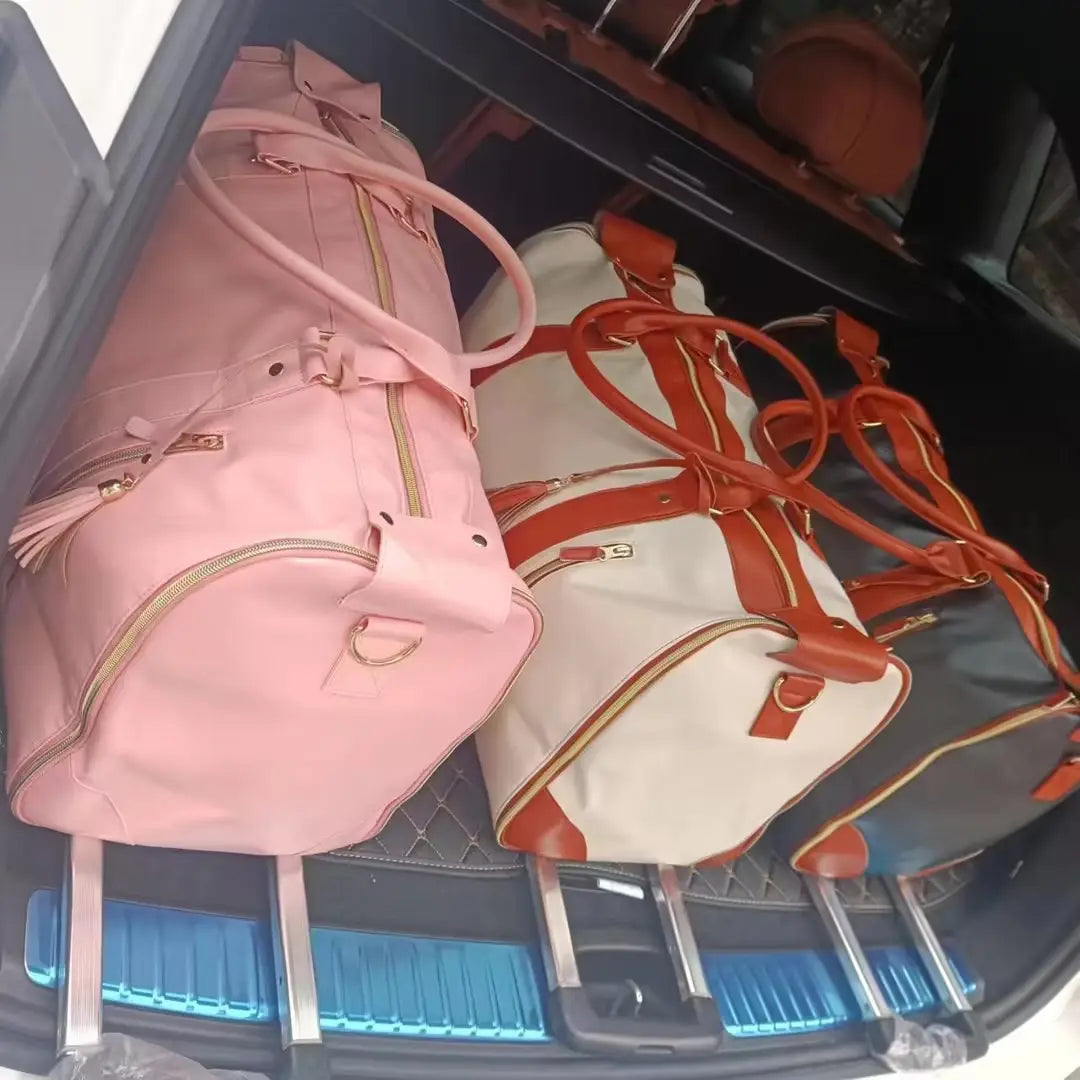 Pink leather rolling travel bag with gold zippers and tassel details foldable large capacity fitness duffel
