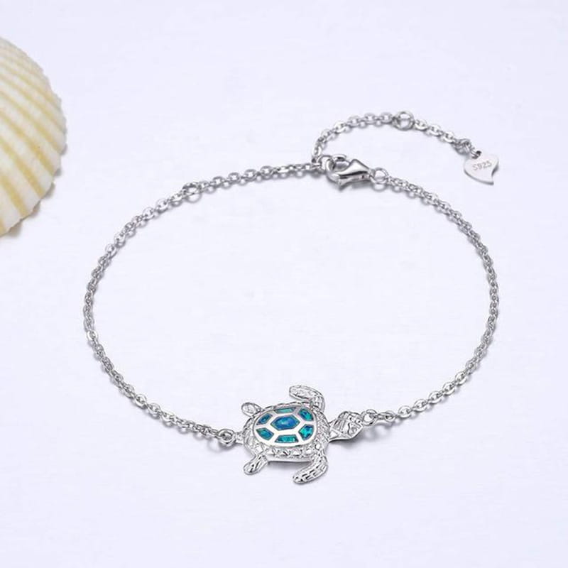 Silver sea turtle opal inlay anklet featuring a delicate silver turtle charm with a turquoise inlaid shell and sparkling crystal accents.