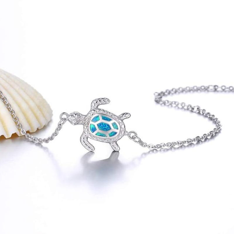 silver sea turtle opal inlay anklet featuring a pendant necklace with a blue opal inlay in silver