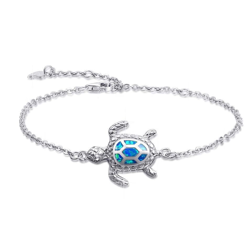 Silver sea turtle anklet featuring a silver bracelet design with a blue opal inlay on the turtle-shaped shell.