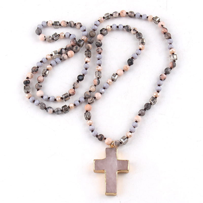 A delicate bohemian natural stone and glass beaded cross necklace featuring soft pastel and earthy-toned beads with metallic accents and a rose quartz cross pendant framed by gold.